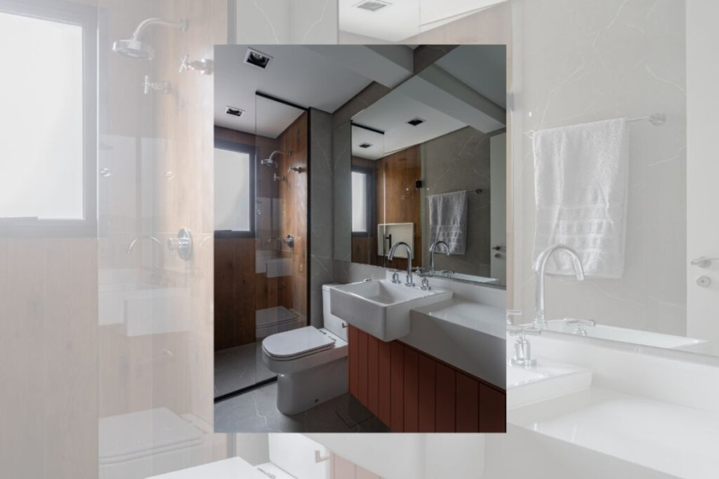 Imagem de banheiro com vaso e pia brancos e pia de madeira. box de vidro ao fundo