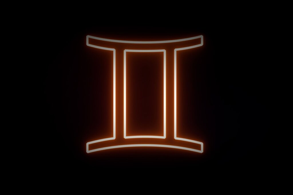 Ilustração digital do símbolo de Gêmeos (o numeral romano para o dois, "II"). O símbolo possui um contorno luminoso em neon laranja e branco sobre um fundo preto.