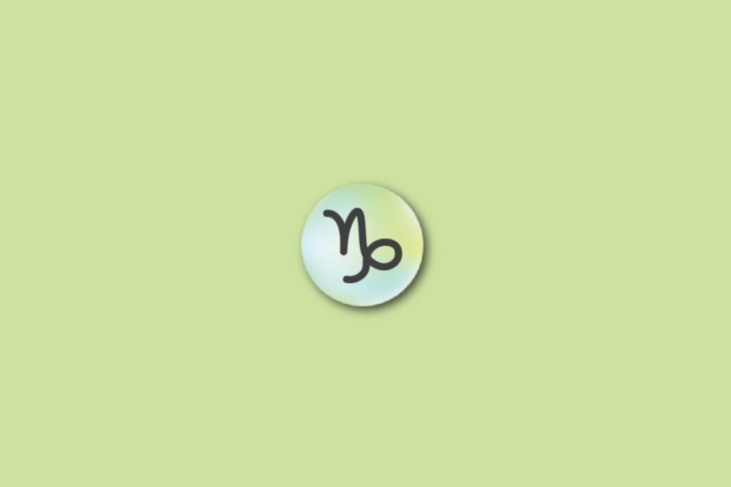 Ilustração do signo de capricórnio, em um círculo com as cores verde, azul e amarelo, sobre um fundo verde