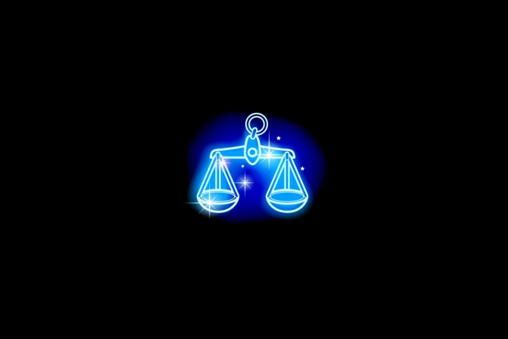 Ilustração do signo de libra em azul sobre um fundo preto