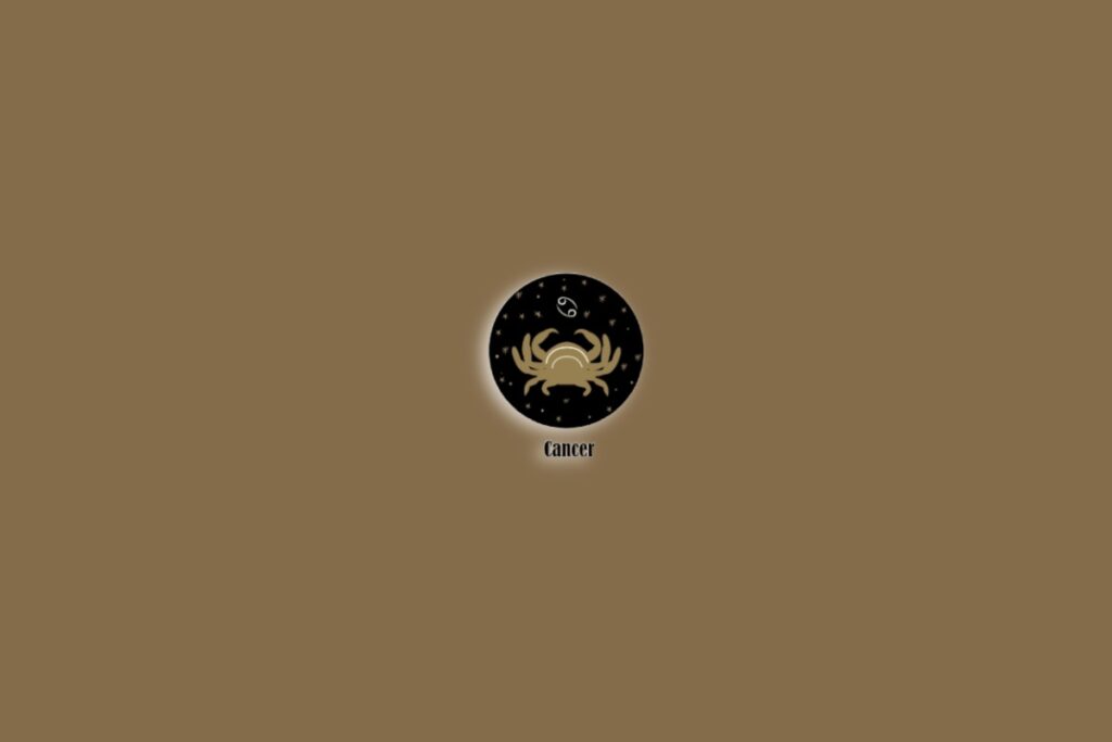 Símbolo do signo de Câncer com a ilustração de um caranguejo sobre um fundo marrom